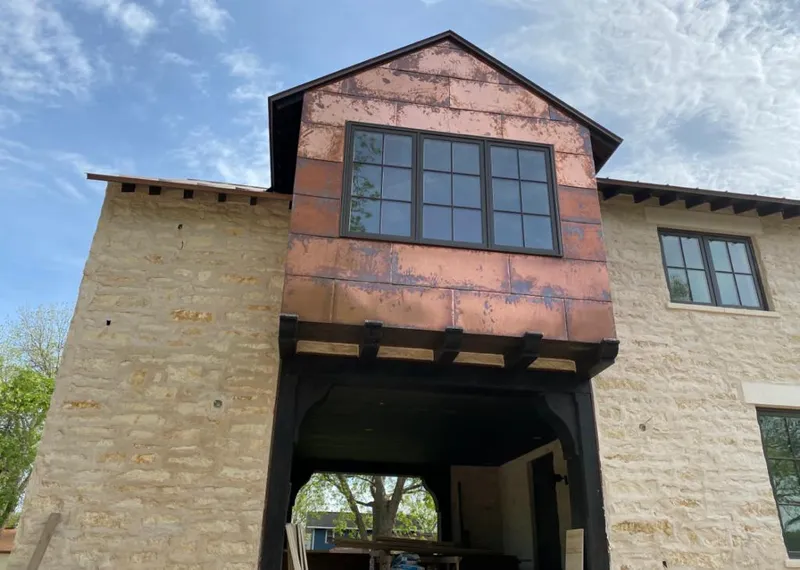 Copper metal panel facade on a stone building for Skylight Installation in Incline Village