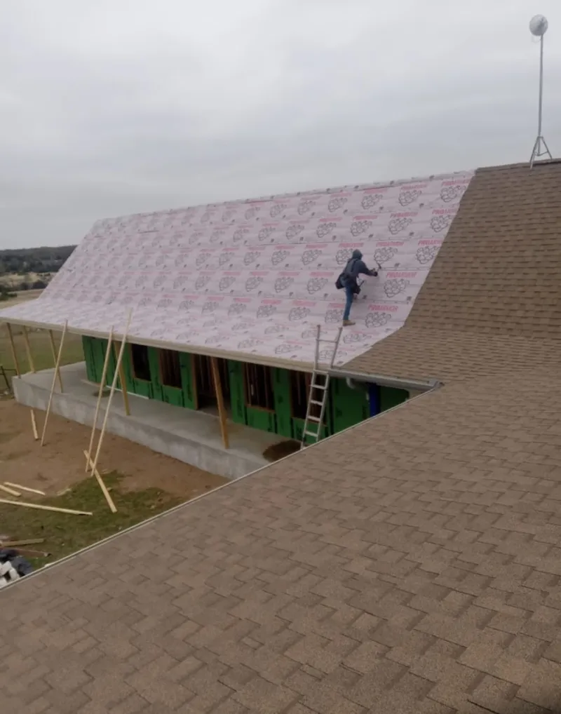 Worker preparing underlayment for a metal roof installation in Incline Village